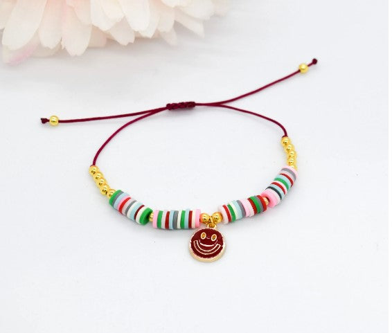 heishi beads bracelet with a happy face charm