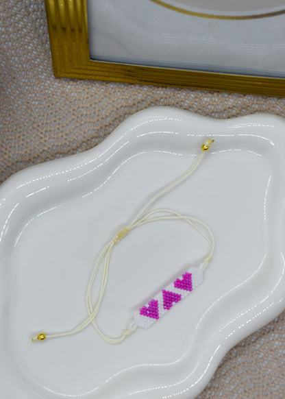 3 pink hearts bracelet on a tray