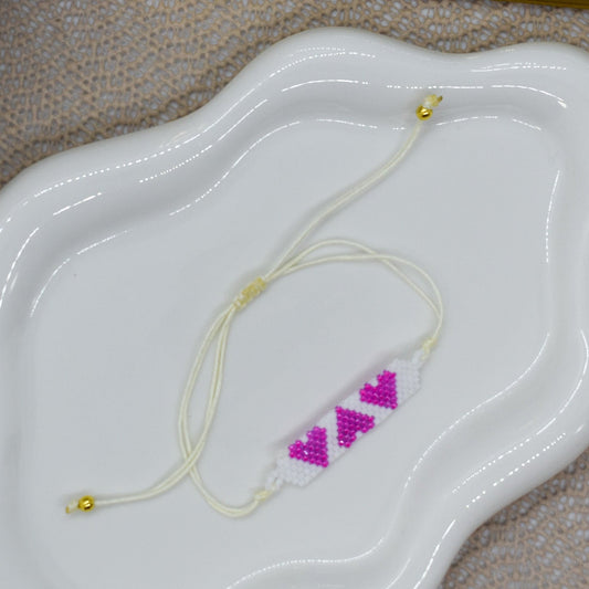 3 pink hearts bracelet on a tray