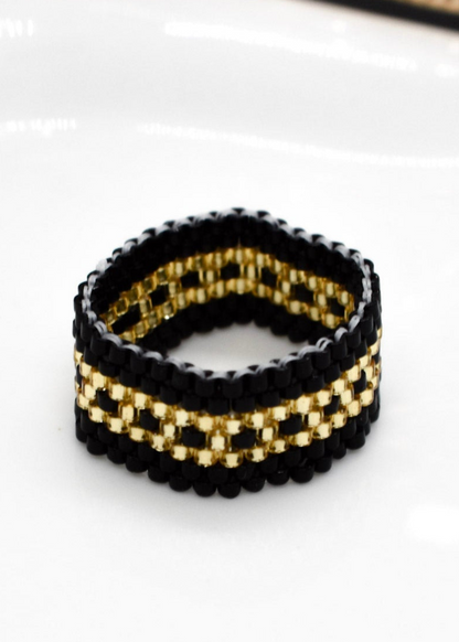 Black and gold beaded bracelet on a white background