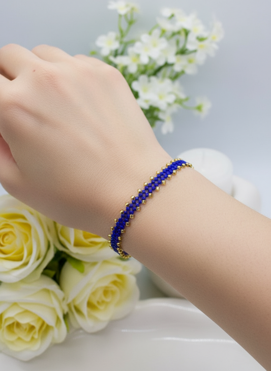 Ai genterated hand wearing a blue beaded bracelet with white flowers and yellow roses in the background