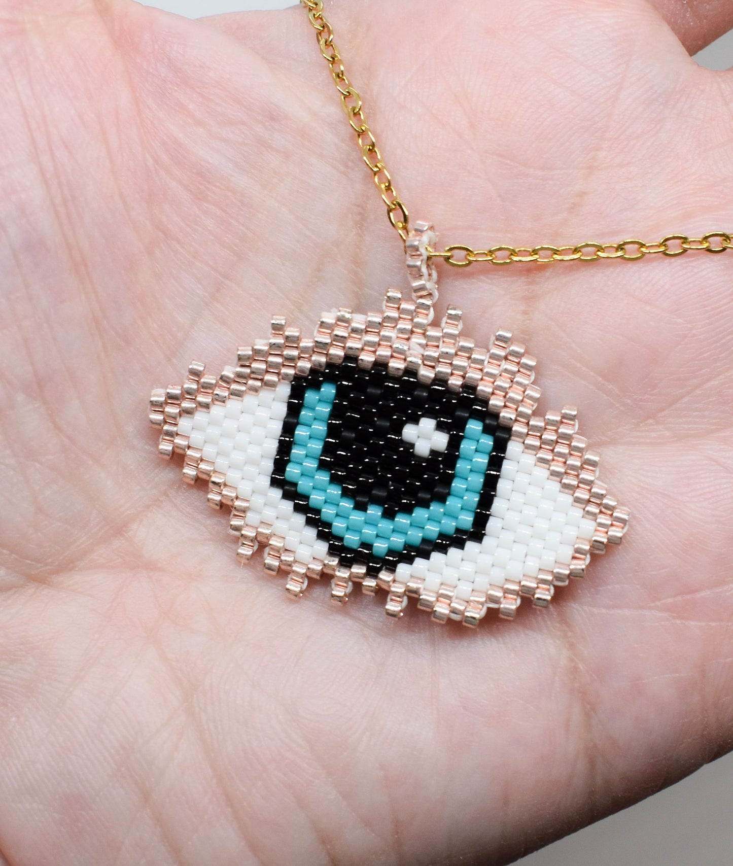 Evil eye beaded necklace on hand