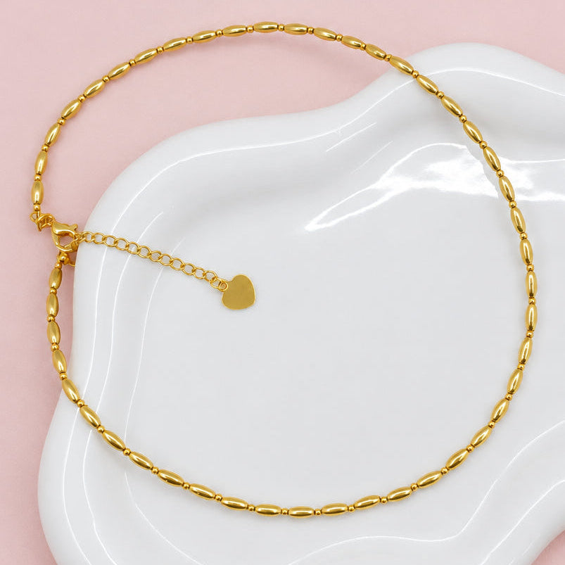 Gold necklace a white dish