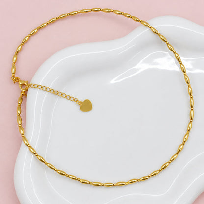 Gold necklace a white dish
