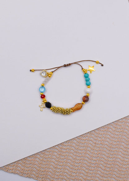 Multicolored Jesus life beaded bracelet on a textured surface