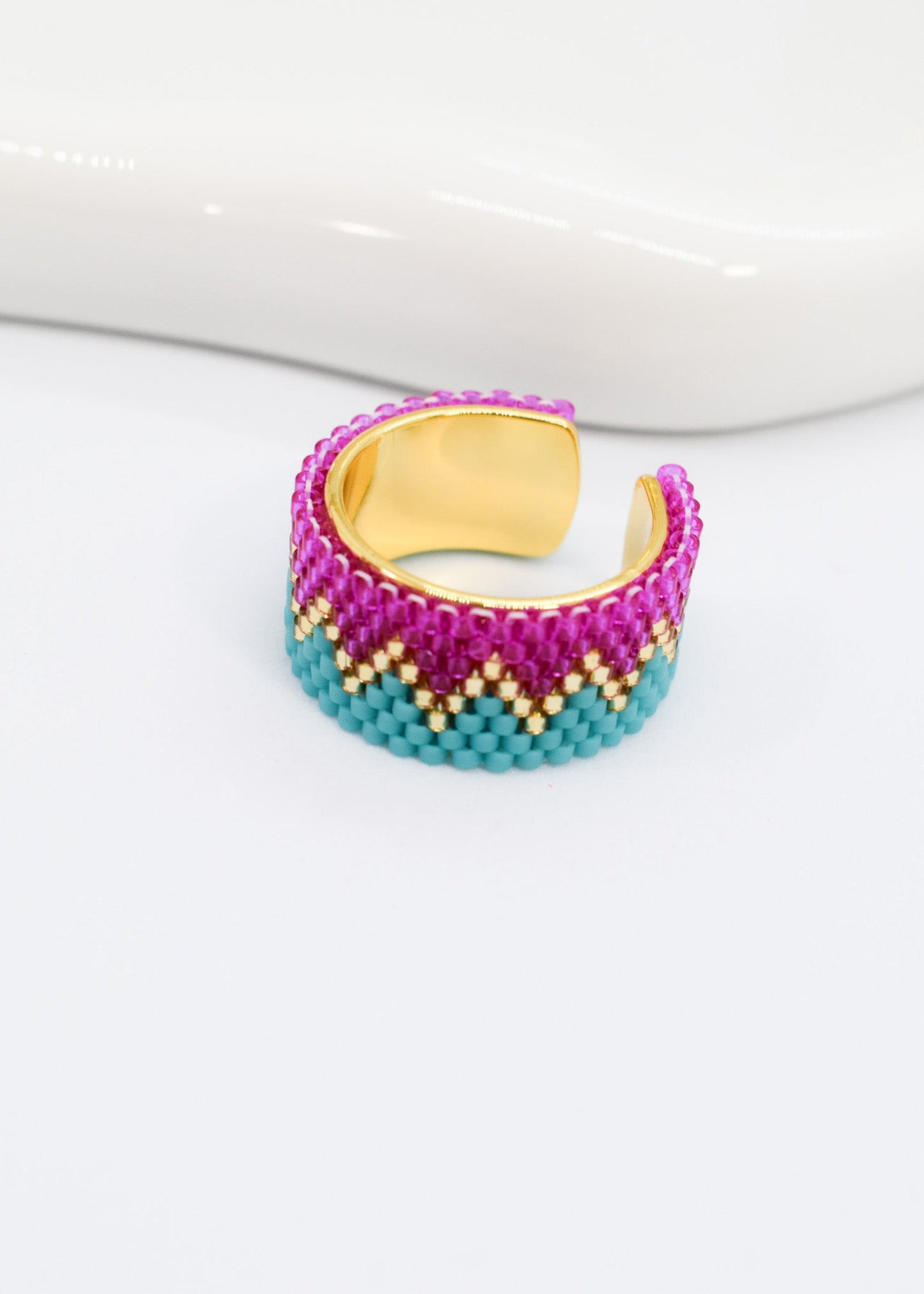 Multicolored beaded ring on a white background