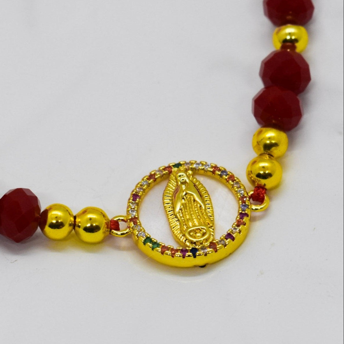 A colorful virgin bracelet surrounded by zirconia crystals with red crystals and red string
