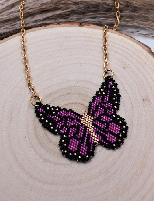 beaded butterfly necklace purple on a wood surface