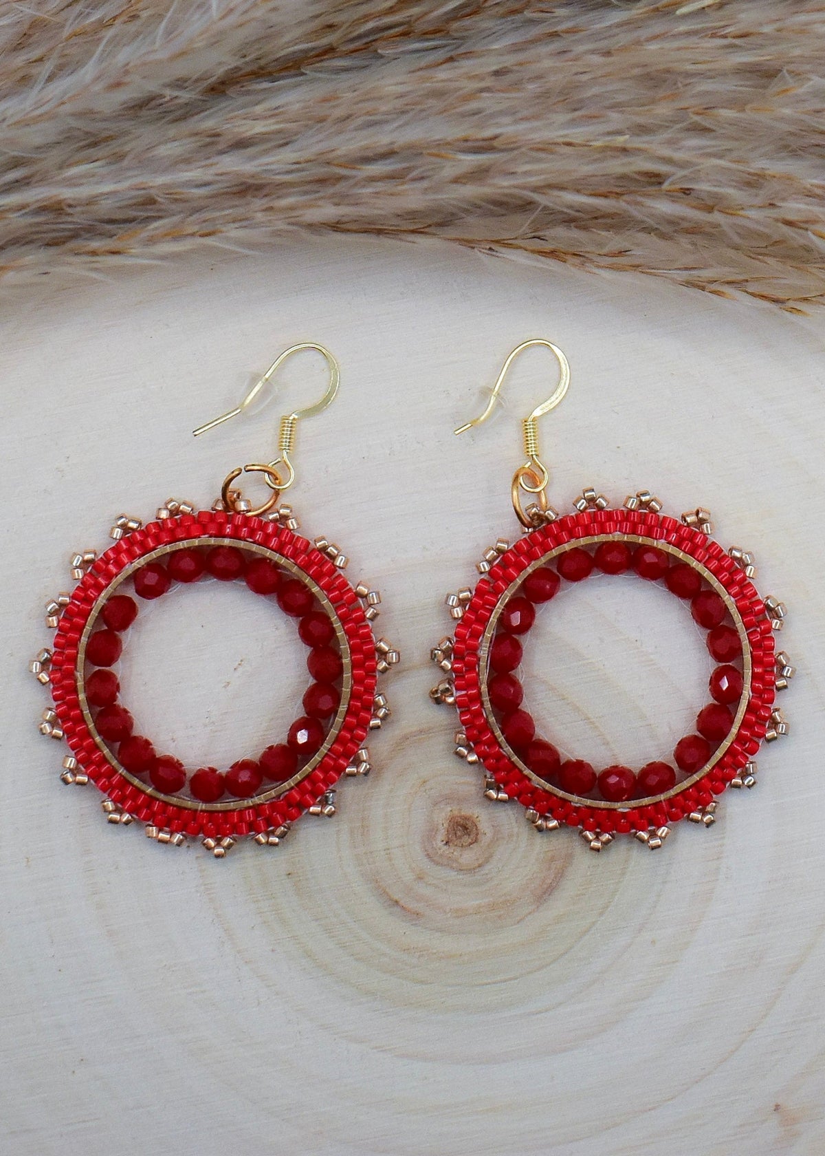 beaded round red miyuki earrings on a wood surface