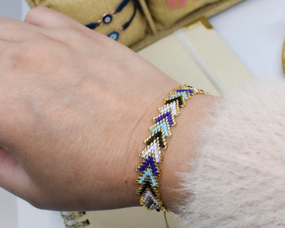 blue arrow bracelet with a jewelry box in the background