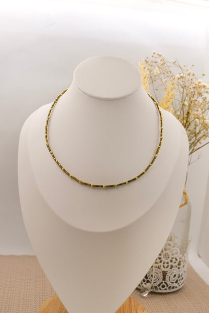 bronze beaded necklace on a bust