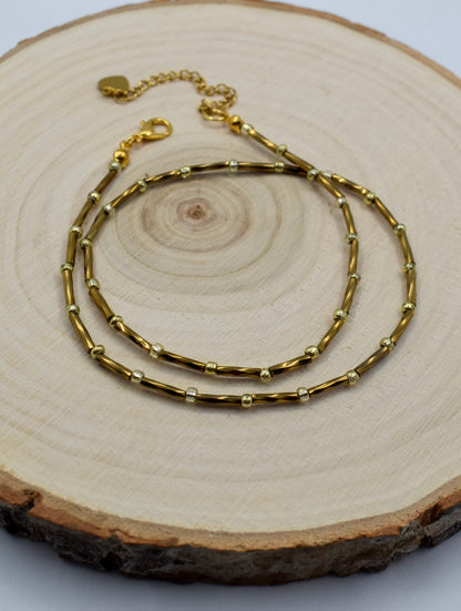 bronze tube necklace on a display