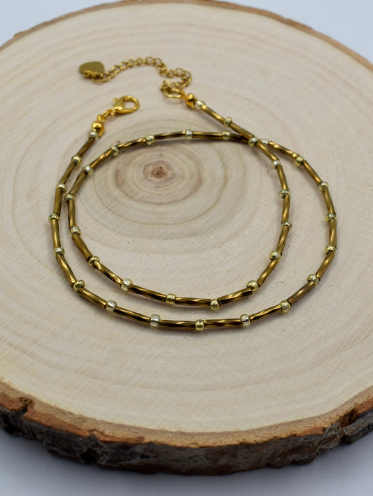 bronze tube necklace on a display