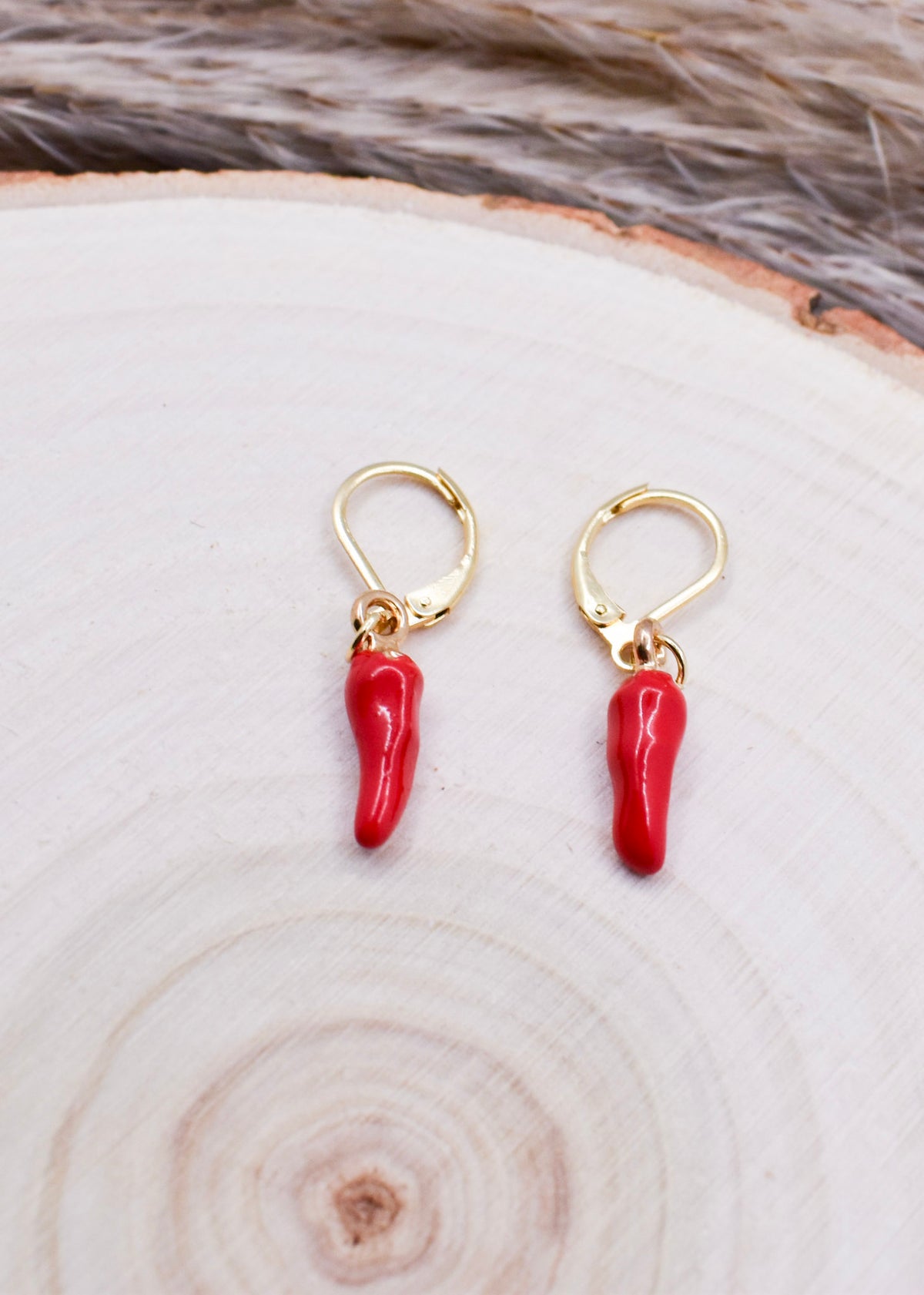 chili earrings hoops on a wood surface