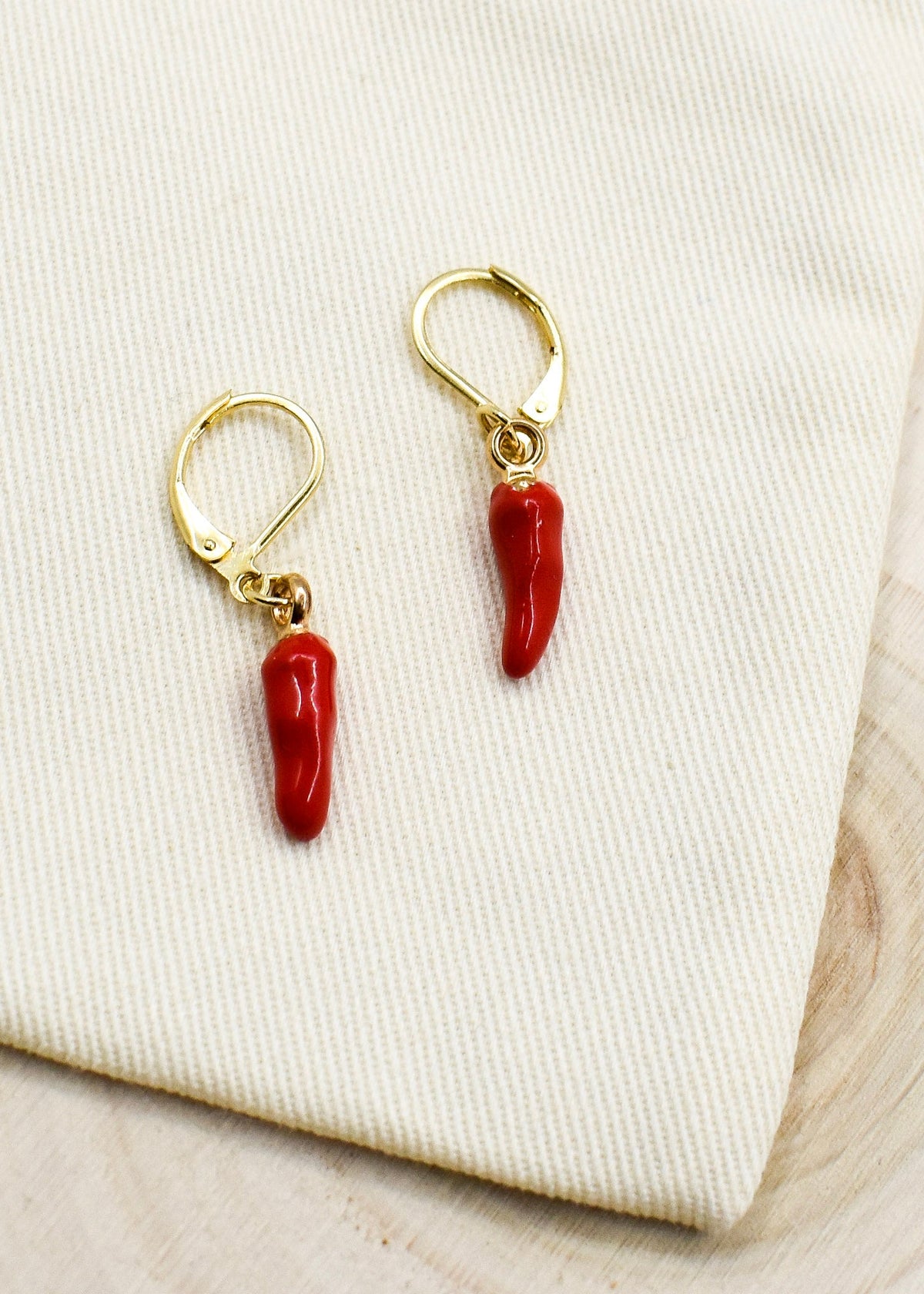 chili pepper charm earrings on a fabric bag