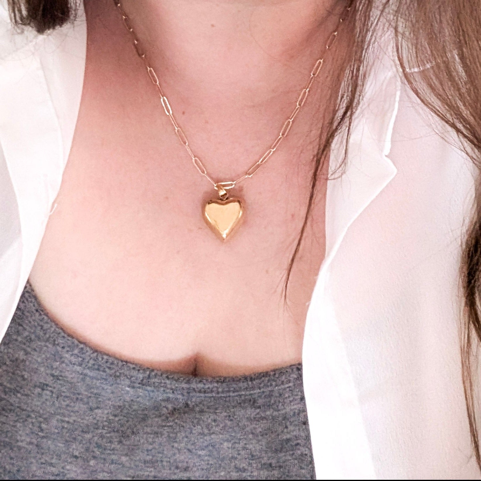 chunky heart necklace on a woman's neck