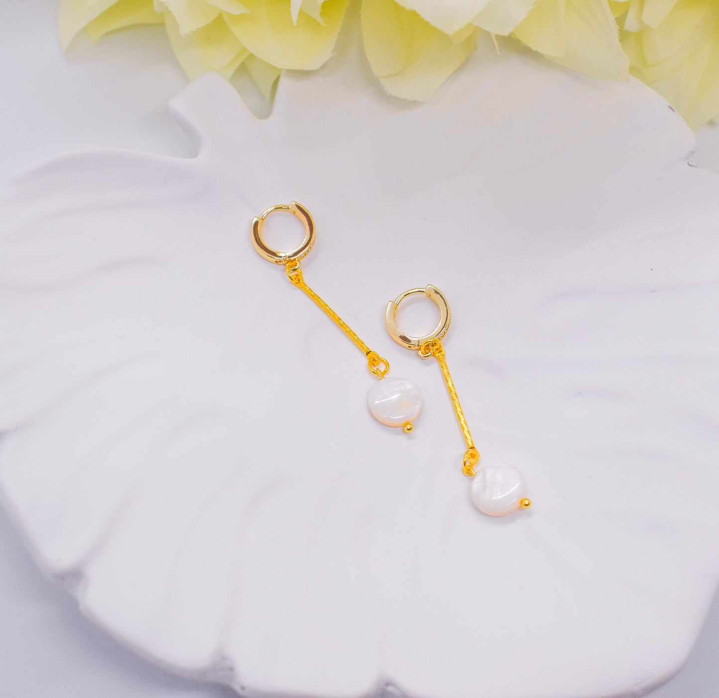 flat pearl earrings on a tray