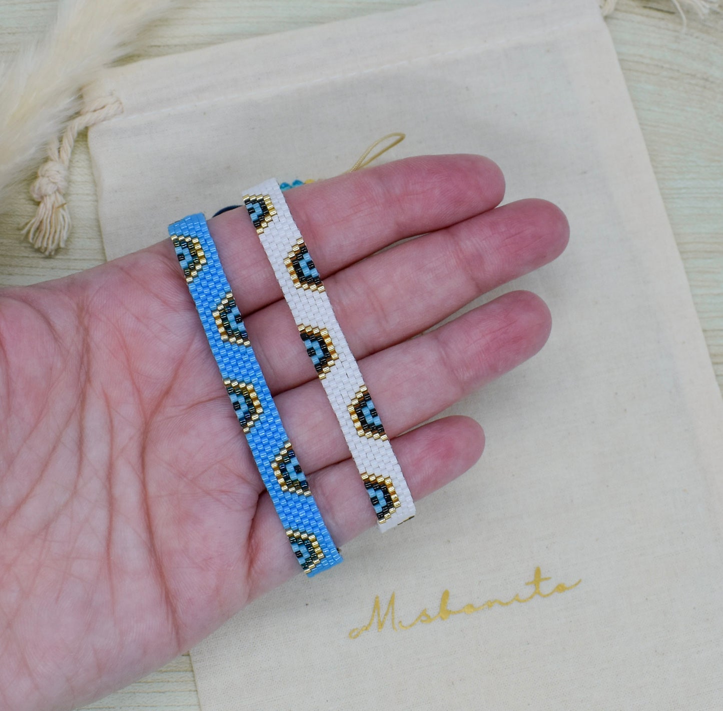 evi leye two blue bracelets on hand