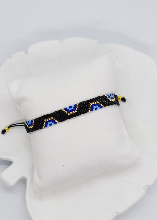 evil eye bar black bracelet on a white display pillow
