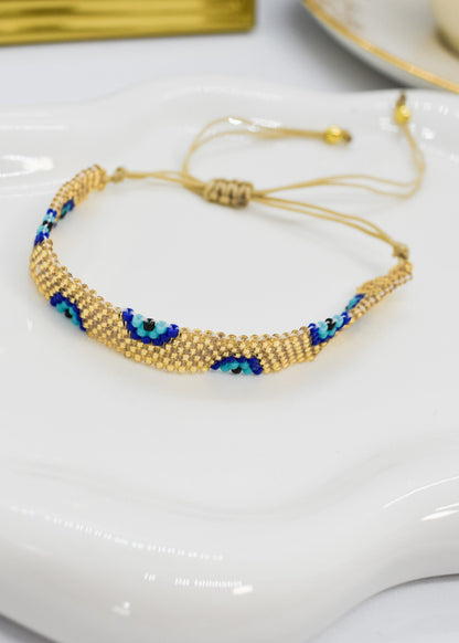 evil eye bar bracelet golden bar on a white tray