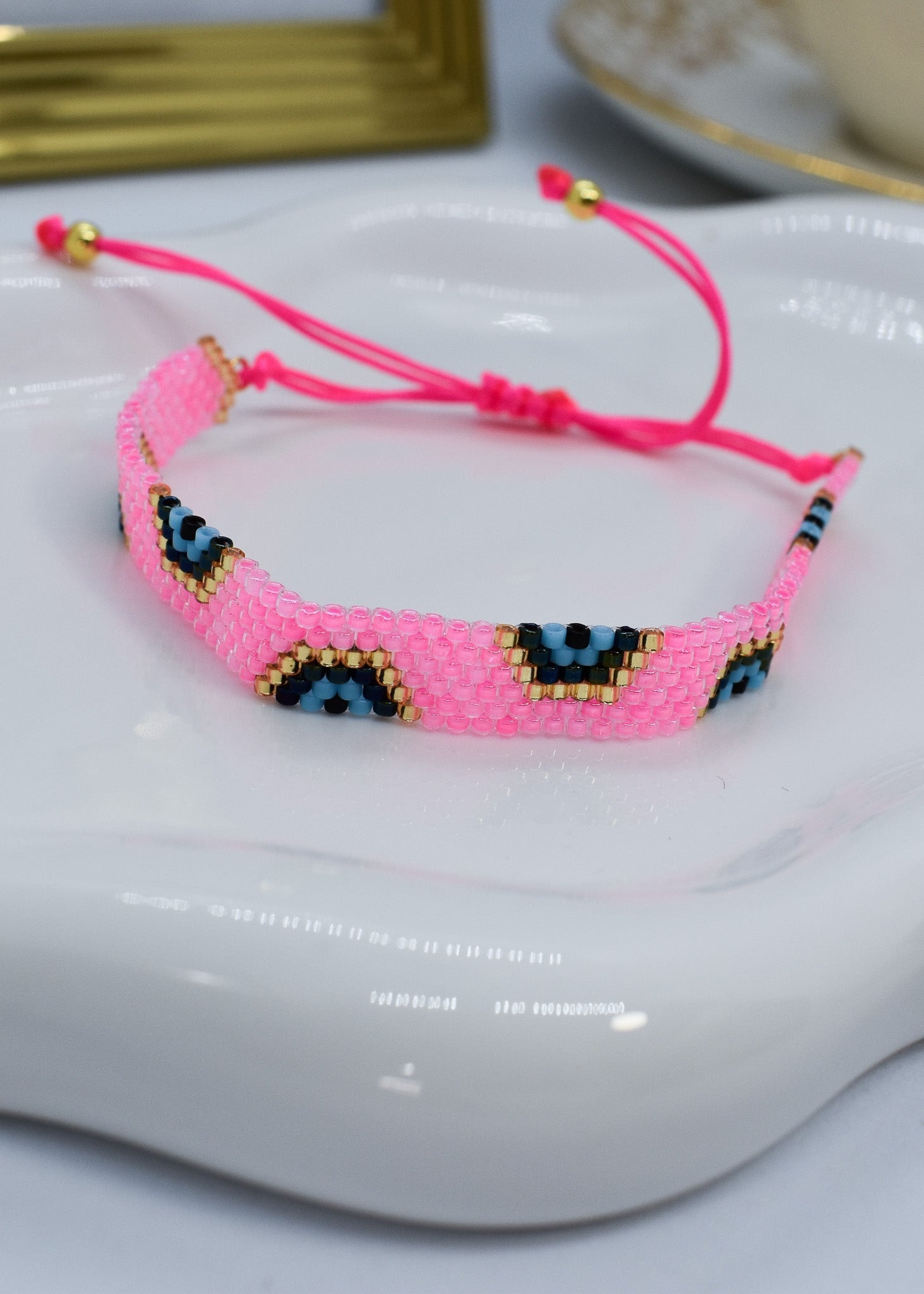 evil eye bar bracelet pink bar on a white tray