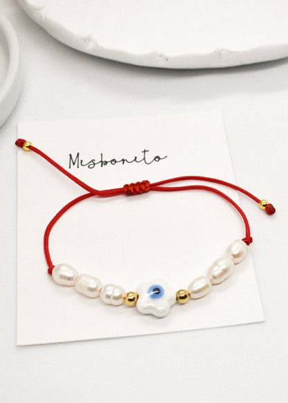 Evil eye pearl bracelet on a card
