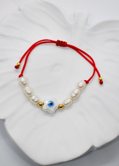 Evil eye pearl bracelet on a tray