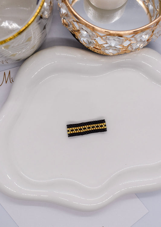 golden and black ring