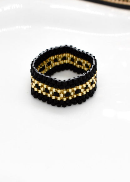golden and black ring beaded