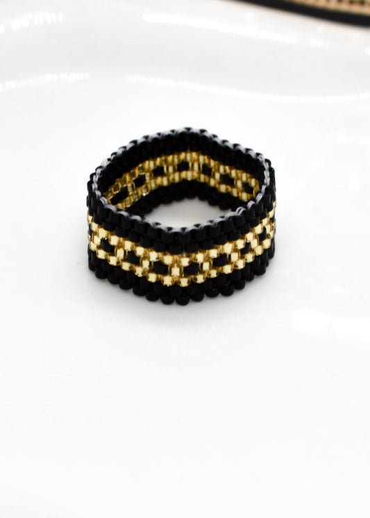 golden and black ring beaded