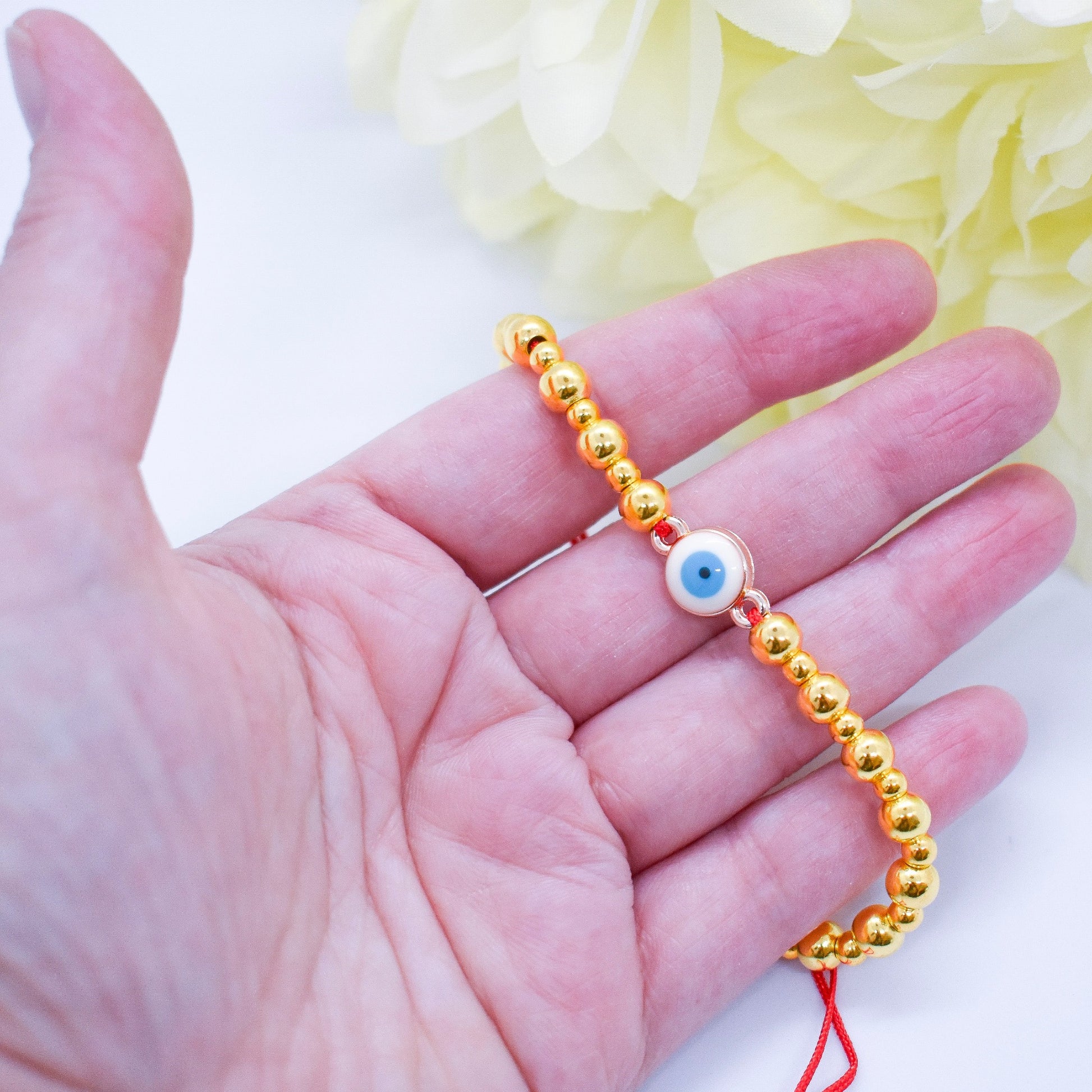 evil eye golden bracelet on hand