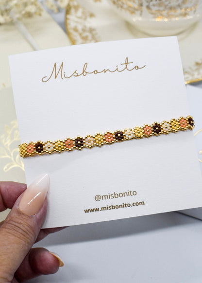 miyuki hexagonal beaded bracelet on a Misbonito branded card held by a hand.