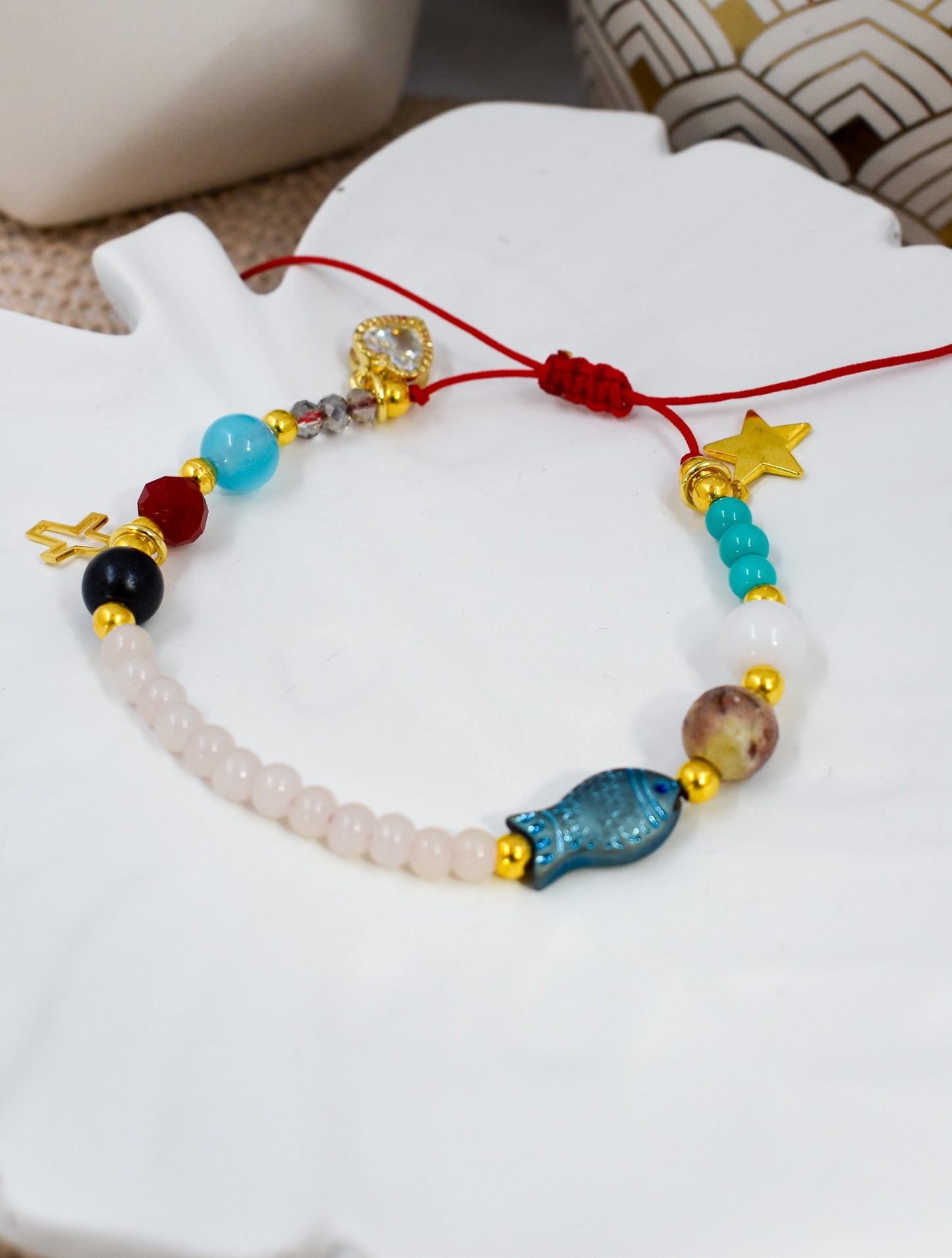 Colorful beaded bracelet with various beads on a white surface