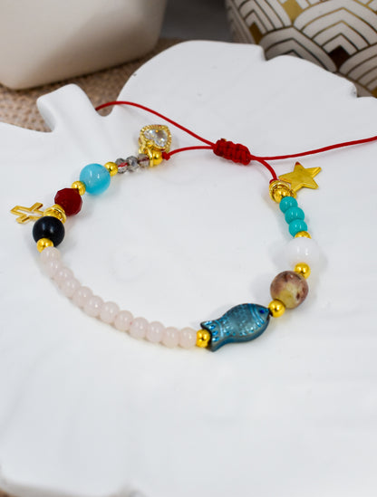 Colorful beaded bracelet with various beads on a white surface
