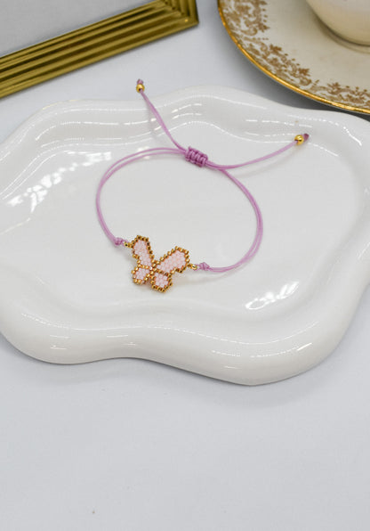 light pink bracelet butterfly on a tray