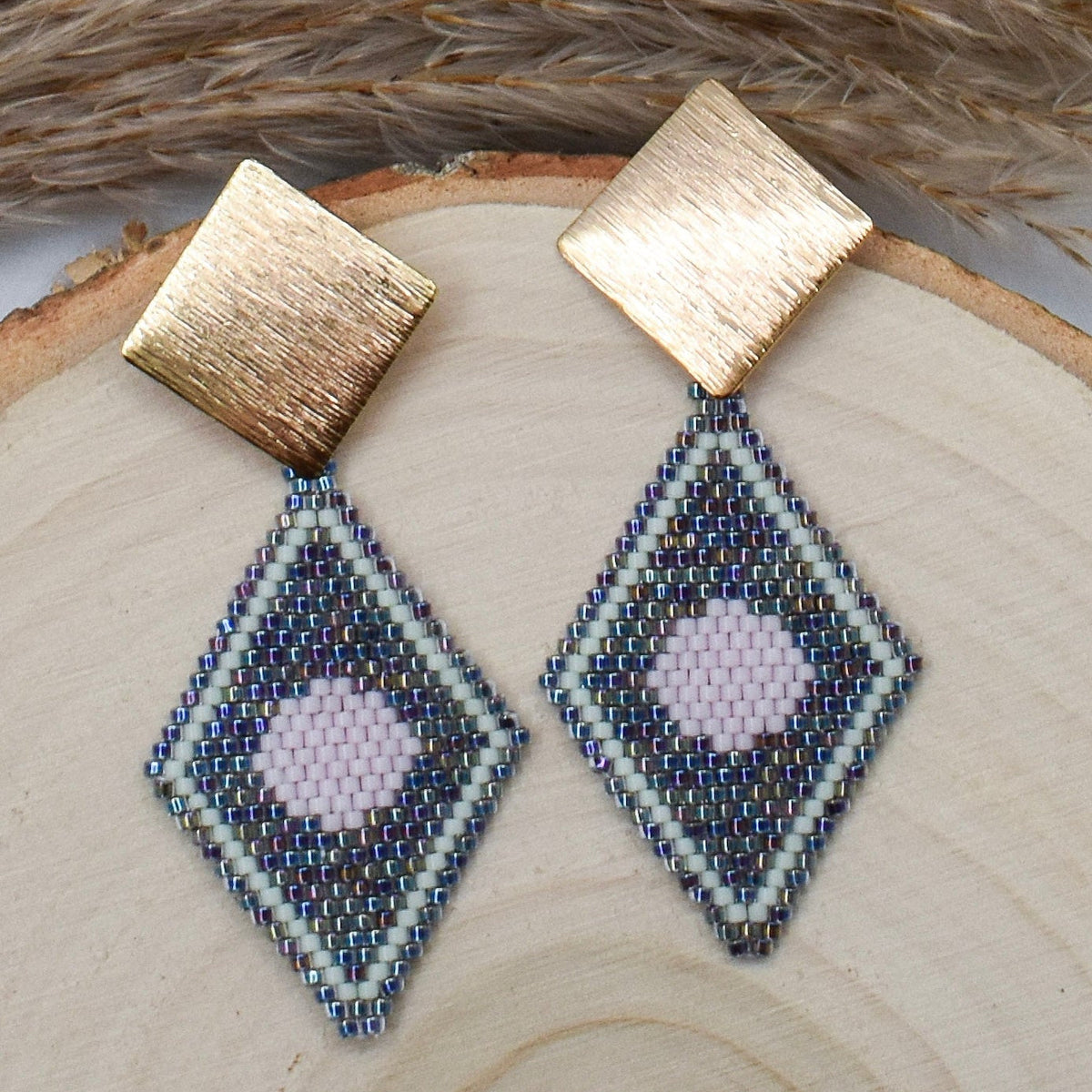full moon beaded earrings on a wood surface