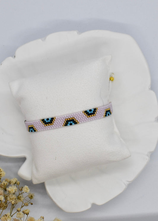 Beaded headband on a pillow with a white background
