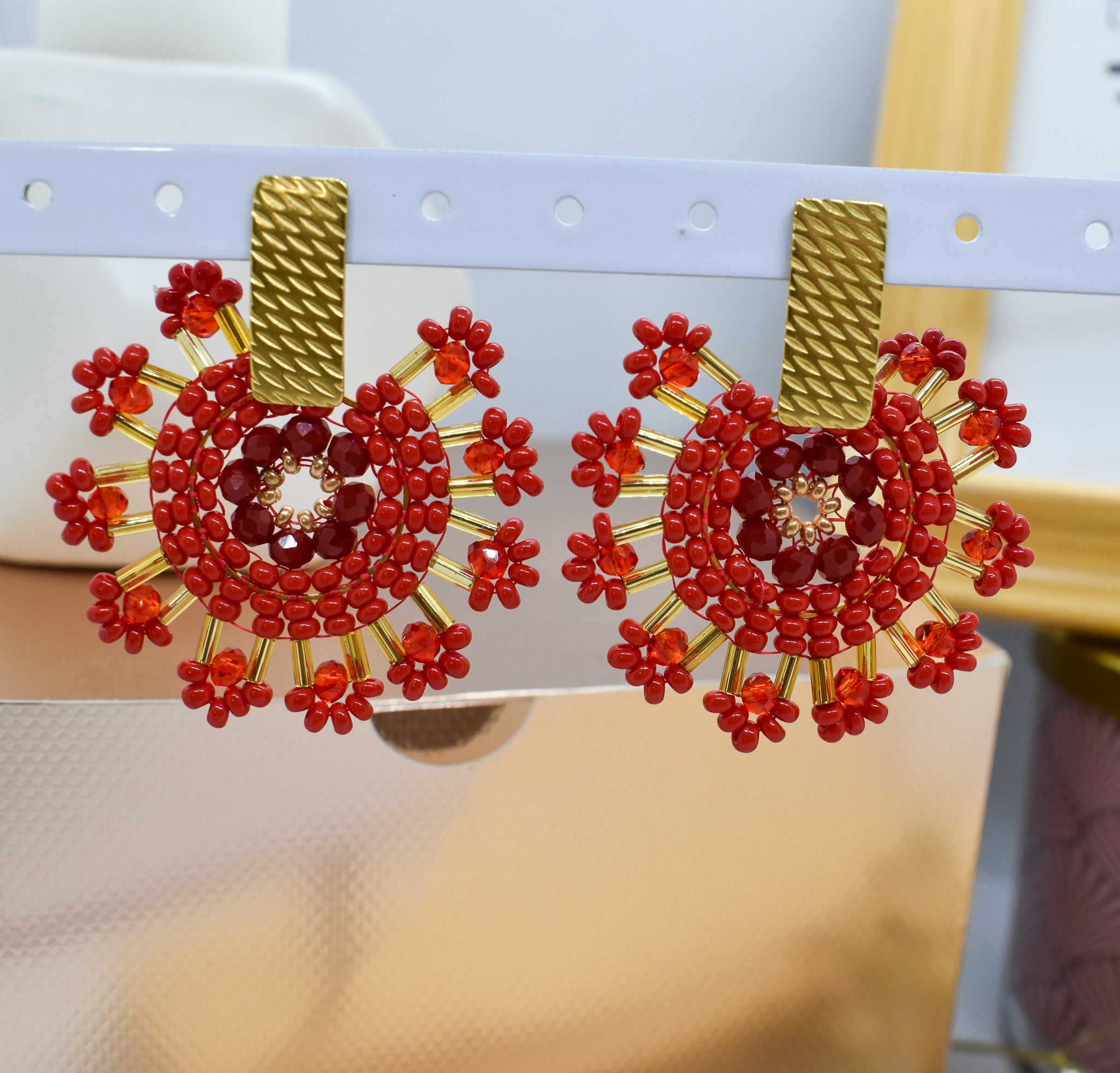 Red beaded earrings with gold accents