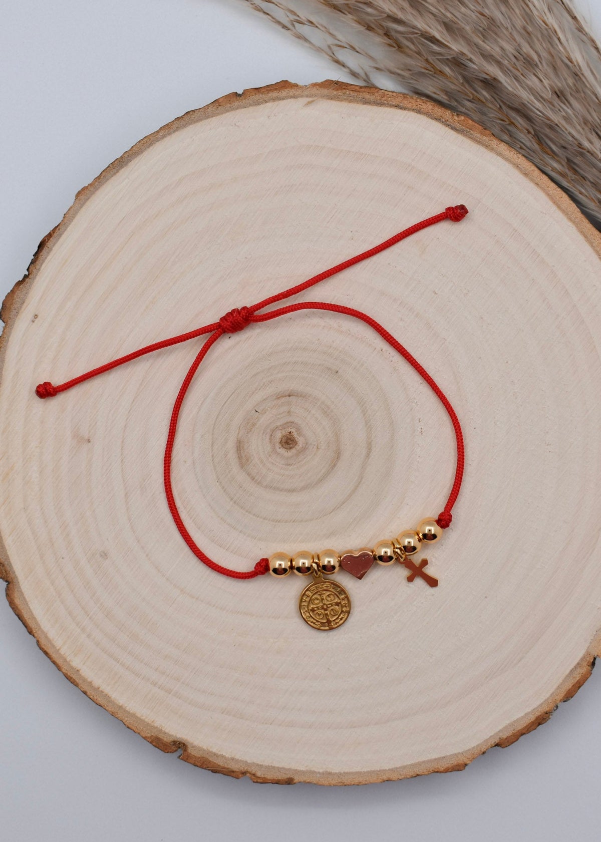 red string bracelet with st benedict and cross