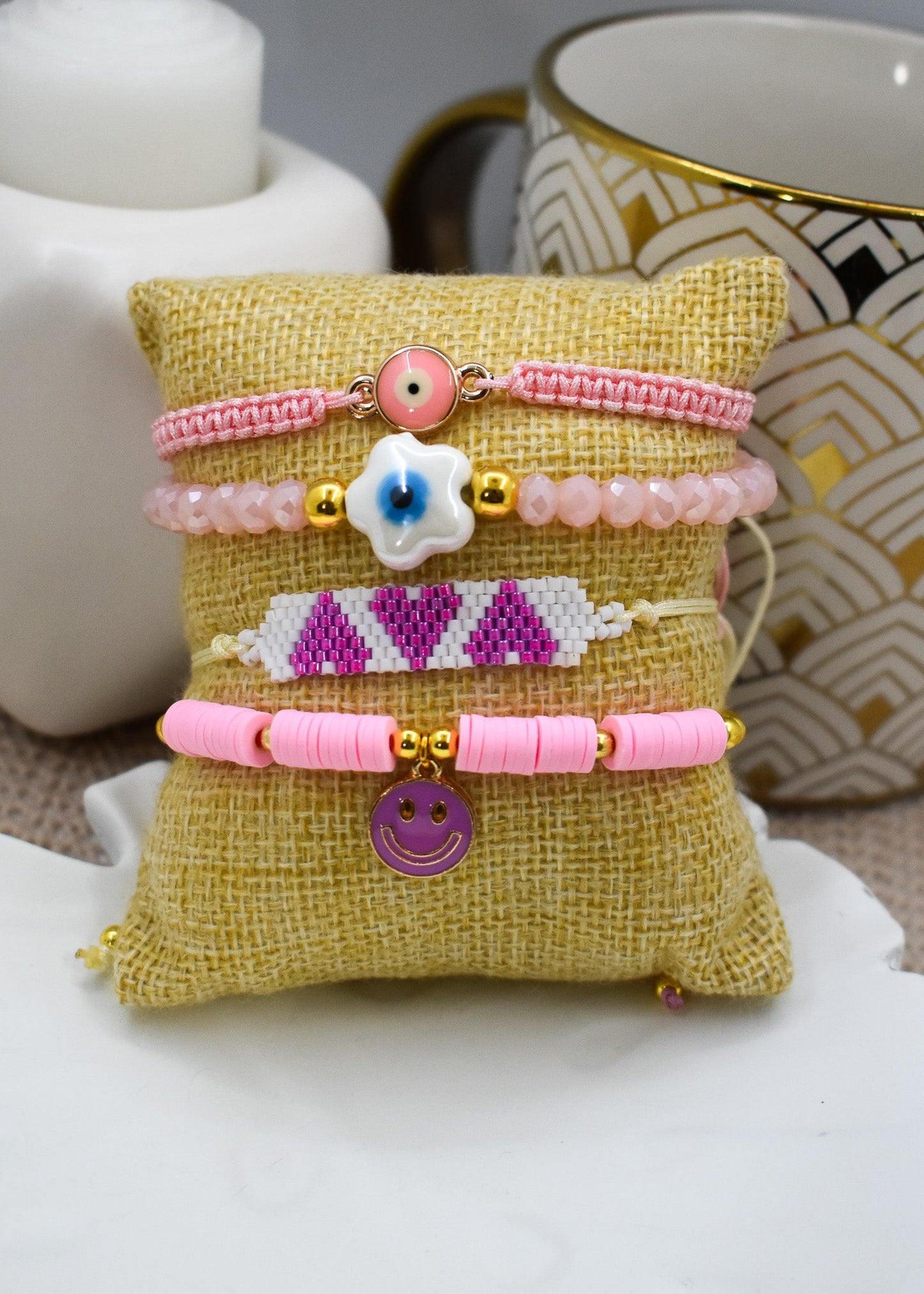 Beaded bracelet with a floral design on a textured pillow against a white background