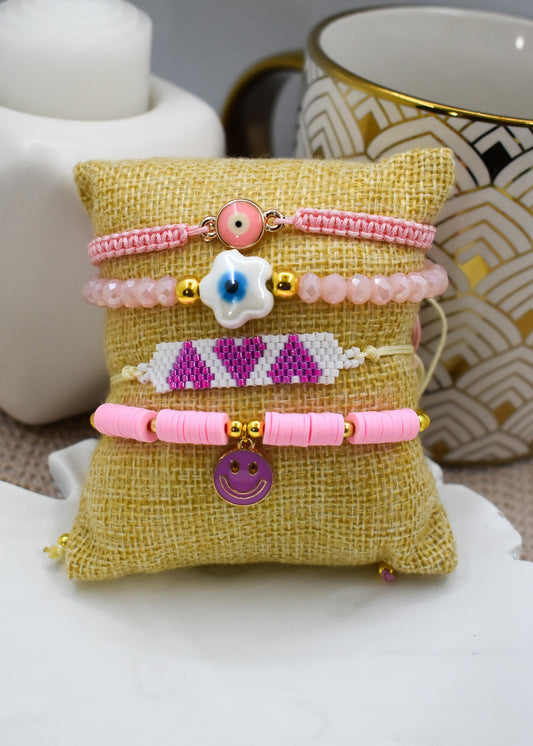 Beaded bracelet with a floral design on a textured pillow against a white background