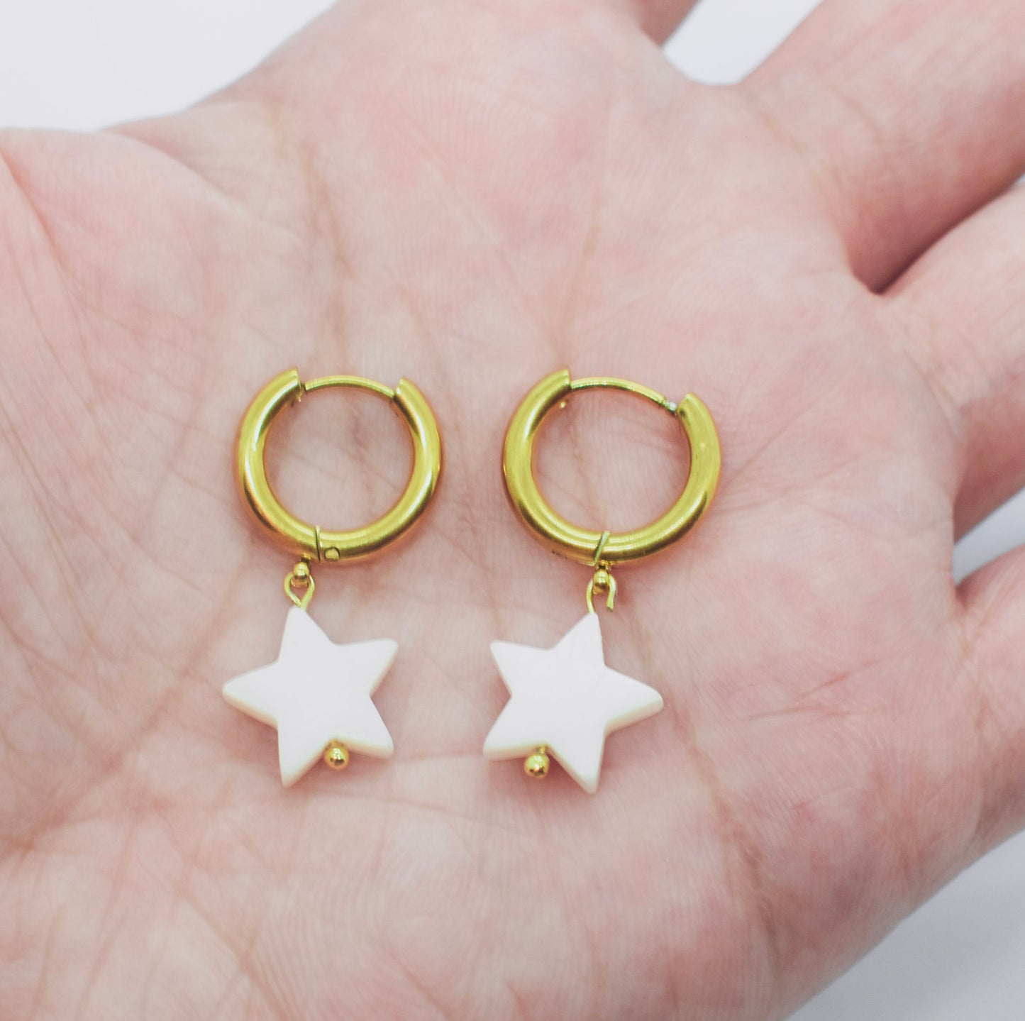 star hoop earrings on hand