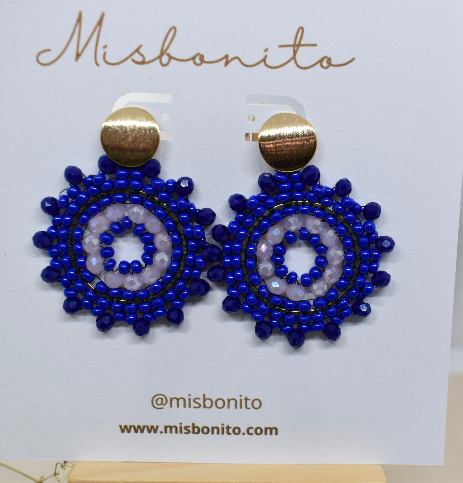 Blue beaded earrings on a Misbonito branded card.