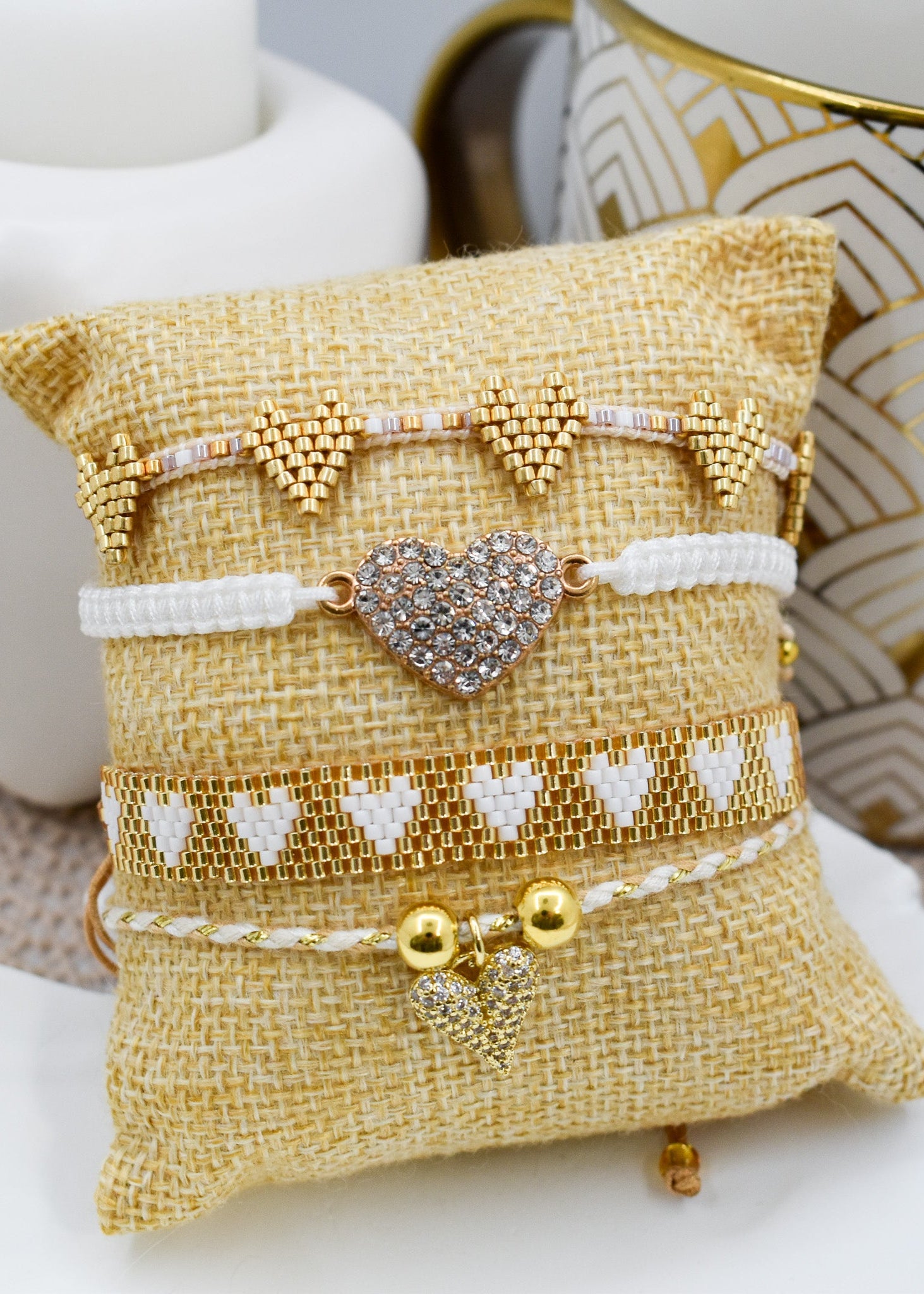 Set of bracelets on a decorative pillow with a heart charm