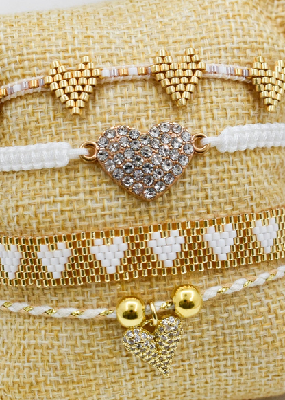 zoomed white_heart_bracelets_set on a pillow